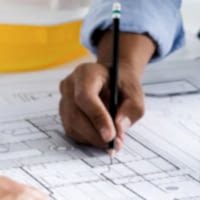 engineer meeting for an architectural project. working with partner and engineering tools working on blueprint architectural project at the construction site at desk in the office.